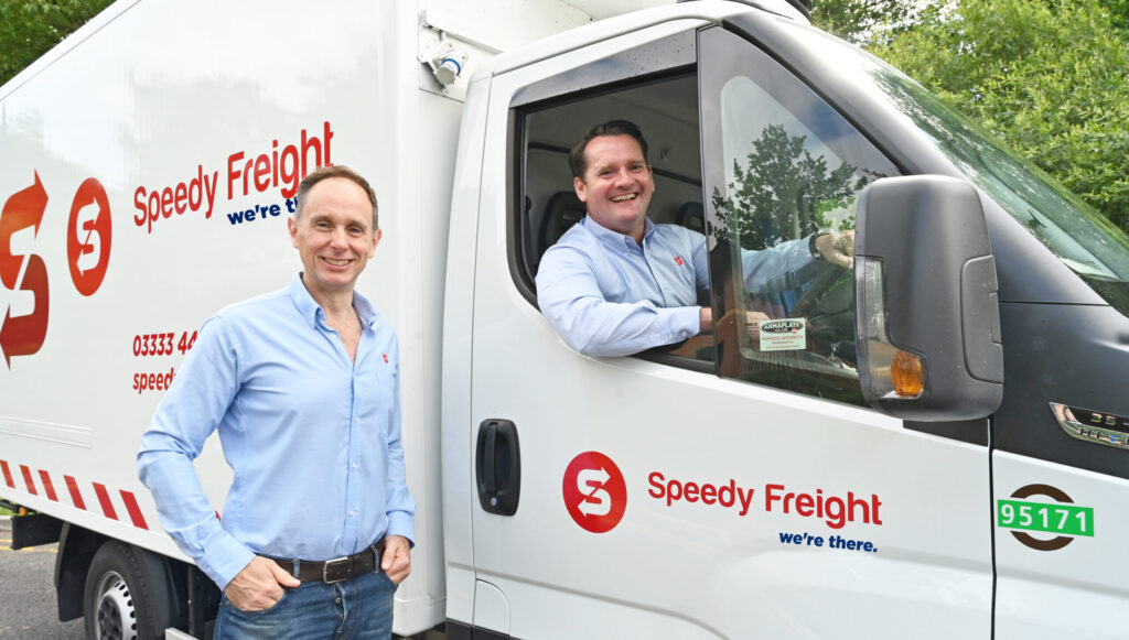 Image shows CEO at Speedy Freight Mike Smith (left) and COO at Speedy Freight John Munnelly (in cab)