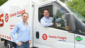 Image shows CEO at Speedy Freight Mike Smith (left) and COO at Speedy Freight John Munnelly (in cab)