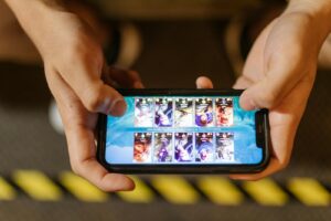 Close-up of hands playing a mobile game on a smartphone, showcasing the game's interface.