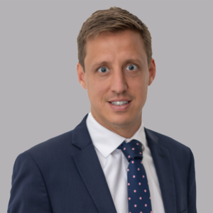 Headshot of Chris Mason wearing a navy suit and white shirt.