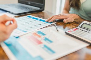 A close up of a bar graph and numerical data on a brown table.