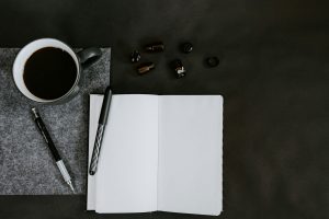 flat lay photo of coffee mug and pencils