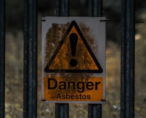 a sign on a metal fence warning of danger